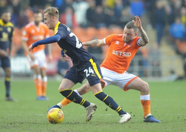 Blackpool's Jay Spearing vies for possession with Oxford United's Mark Sykes