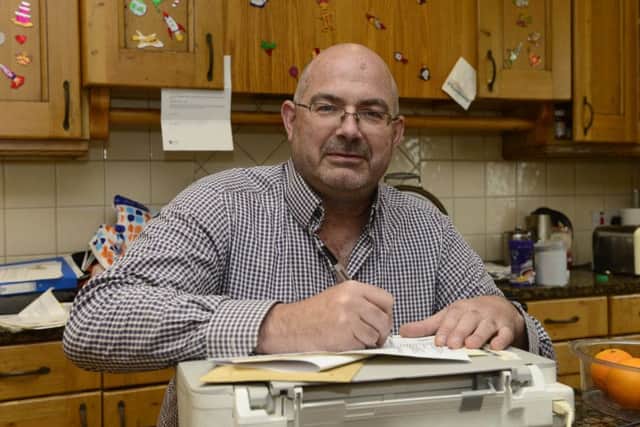 Paul is constantly checking over his finances at his home in Saintfield. 
Photo: Arthur Allison/Pacemaker Press