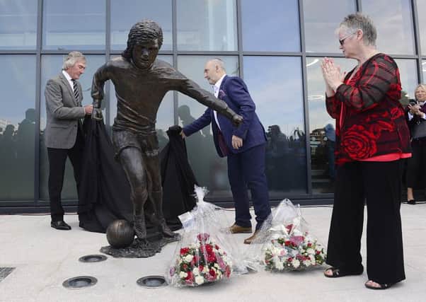 George Best statue unveiled in Belfast, Northern Ireland. The life sized statue sits outside the Olympia Leisure Centre - just yards away from Windsor Park where Best played many games for Northern Ireland. Pictured at the unveiling Pat Jennings former Northern Irish footballer, Barbara McNarry George Best's sister and football fan Robert Kennedy unveil the statue.