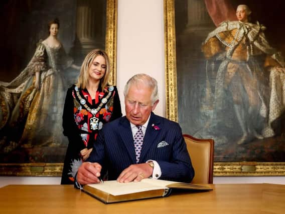 The Prince of Wales signing the visitors book at the Palace Demesne, Armagh. Photo by William Cherry/Presseye