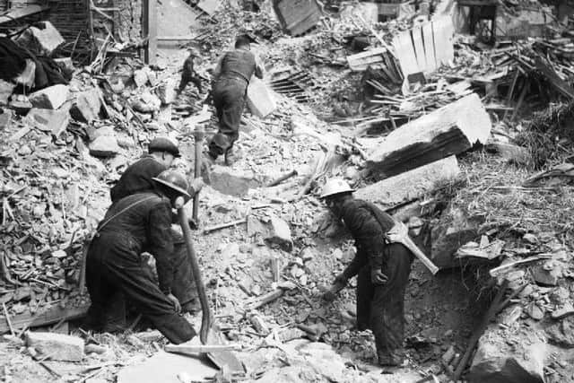 Rescue workers search through the rubble in Belfast after a German Luftwaffe Easter raid, 1941