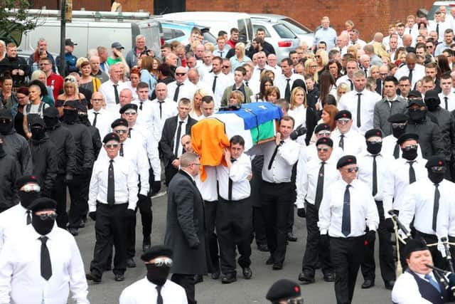 A large crowd of people walked behind Martin McElkerneys coffin, which was flanked by masked men
