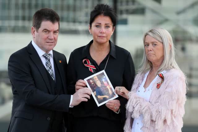 John Conway with his sisters Christina McLaughlin (centre) and Patricia Kelly, hold a photograph of their brother Seamus Conway who died last year at 45 from liver cancer after contracting hepatitis C from contaminated blood product
