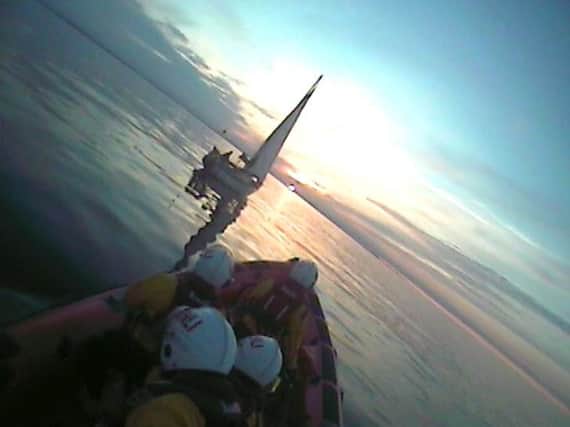 The RNLI crew go to the rescue of the stricken yacht.