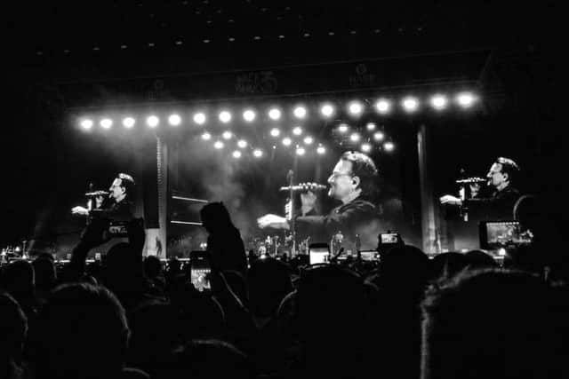 U2 frontman Bono on stage with Snow Patrol at Ward Park on Saturday.