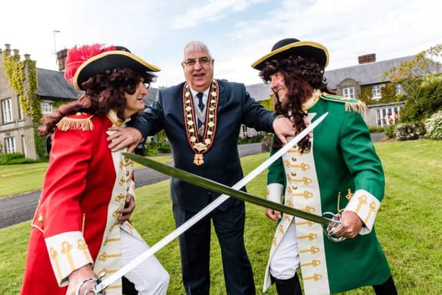 Sovereign grand master, Rev William Anderson, attempts to keep King William (left) and King James apart ahead of battle at this year's Sham Fight in Scarva.