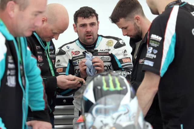 Ballymoney man Michael Dunlop in discussion with his MD Racing team during Isle of Man TT qualifying on Sunday. Picture: Stephen Davison/Pacemaker Press.