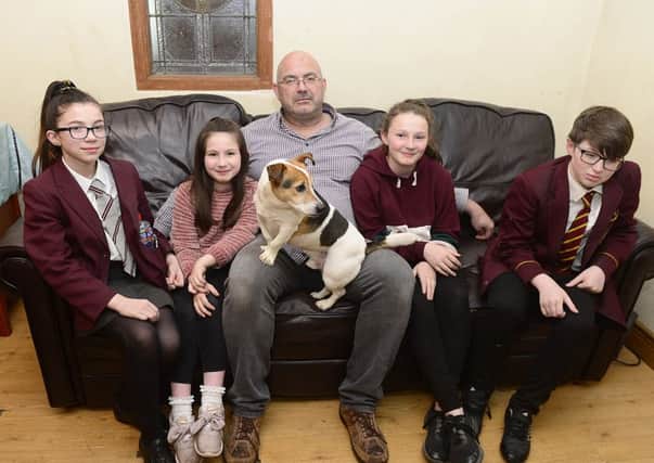 Paul Steward at home in Saintfield with four of his six children, Olivia, Gemma, their dog Jack, Ellen and Stan.
 He has found being put onto Universal Credit has put him under significant financial pressure. Photo: By: Arthur Allison/Pacemaker Press