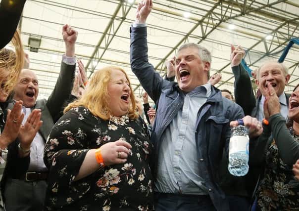 A jubilant Naomi Long celebrating her victory with husband Michael