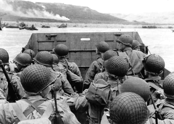 US troops on board a landing craft approach their target beach in Normandy on June 6, 1944.  More than 130,000 Allied troops took part in the landings