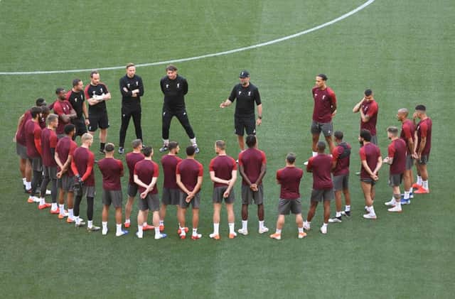 Liverpool manager Jurgen Klopp (centre top) leads a team huddle during a training session at the Estadio Metropolitano