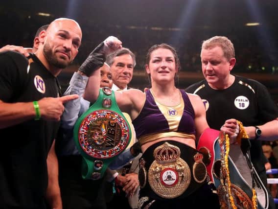 Katie Taylor with all the belts