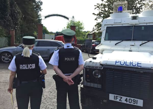 Police and army bomb disposal experts at Shandon Park Golf Club in east Belfast after the suspect device was found under a police officer's car. Photo: David Young/PA Wire