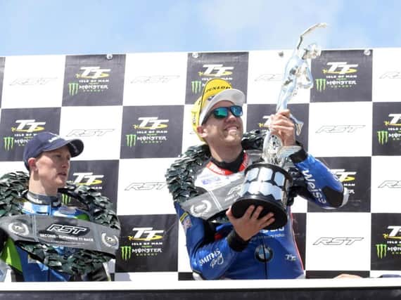 Peter Hickman celebrates his RST Superbike victory at the Isle of Man TT with runner-up Dean Harrison.