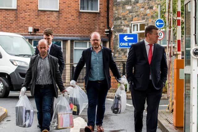 Investigative journalists Barry McCaffrey (left) and Trevor Birney carry returned documents in Belfast, after a haul of journalistic material was unlawfully seized by police following the making of the Loughinisland documentary, No Stone Unturned. (Photo: Liam McBurney/P.A. Wire)