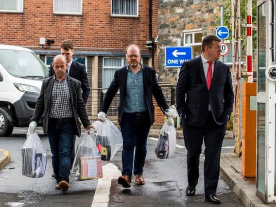 Investigative journalists Barry McCaffrey (left) and Trevor Birney carry returned documents in Belfast, after a haul of journalistic material was unlawfully seized by police following the making of the Loughinisland documentary, No Stone Unturned. (Photo: Liam McBurney/P.A. Wire)