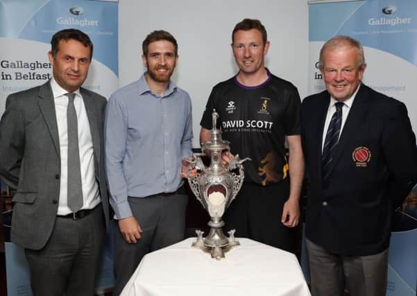Gary Kidd of holders Waringstown (second left) and Andrew White of Instonians at the draw for the quarter-finals of the NCU's Gallagher Senior Challenge Cup.  The two clubs will meet if Waringstown defeat
Holywood in  their postponed first round game on Sunday. Also pictured are Shane Matthews, managing director of Gallagher in
Northern Ireland, and Richard Johnson, president of the NCU.
