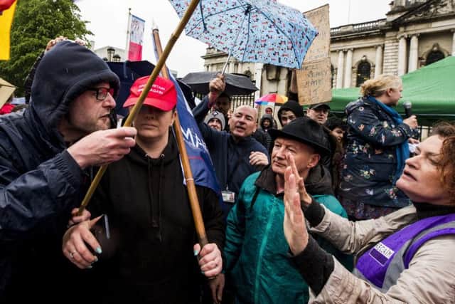 RETRANSMITTED CORRECTING SPELLING OF CUMMINGS

Wayne Cummings (left) with his partner former Belfast Councillor Jolene Bunting (second from left) speaking with a steward during a corner protest at a "Stop Trumpism" rally hosted by ExAct: Expat Action Group NI, at Belfast City Hall. PRESS ASSOCIATION Photo. Picture date: Tuesday June 4, 2019. See PA story IRISH Trump Belfast.  Photo credit should read: Liam McBurney/PA Wire