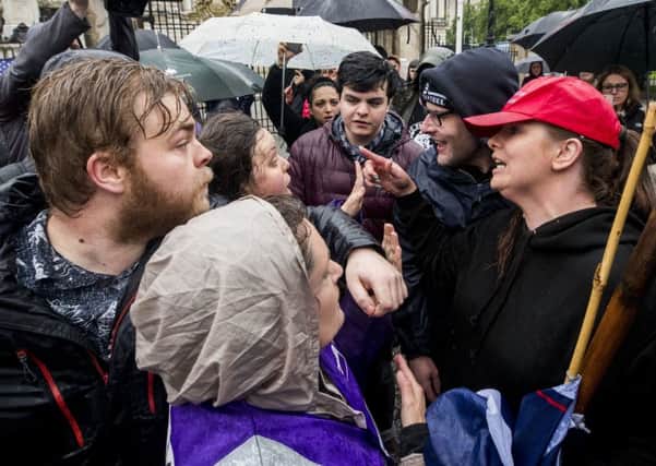 Former Belfast Councillor Jolene Bunting (right) with her partner Wayne Cummings (second from right) speaking with a stewards during a corner protest at a "Stop Trumpism" rally hosted by ExAct: Expat Action Group NI, at Belfast City Hall. PRESS ASSOCIATION Photo. Picture date: Tuesday June 4, 2019. See PA story IRISH Trump Belfast.  Photo credit should read: Liam McBurney/PA Wire