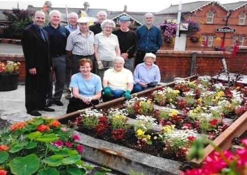 Volunteers of Brighter Whitehead planting at Whitehead Railway Station