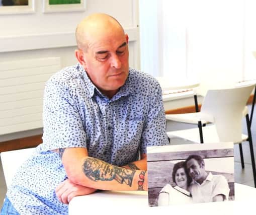 Philip Cloete with a photograph of his parents. (Photo: Donal Dunn).