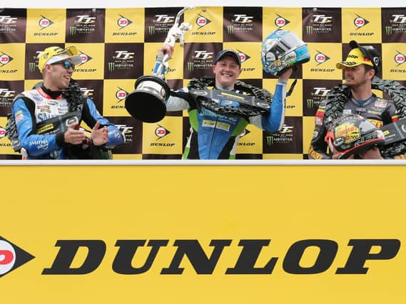 Dean Harrison celebrates his victory in the Dunlop Senior TT with runner-up Peter Hickman (left) and Conor Cummins.