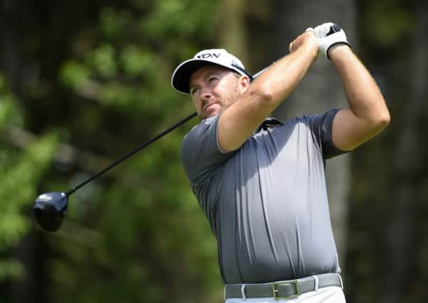 Graeme McDowell watches his tee shot on the fifth hole during the first round of the Canadian Open
