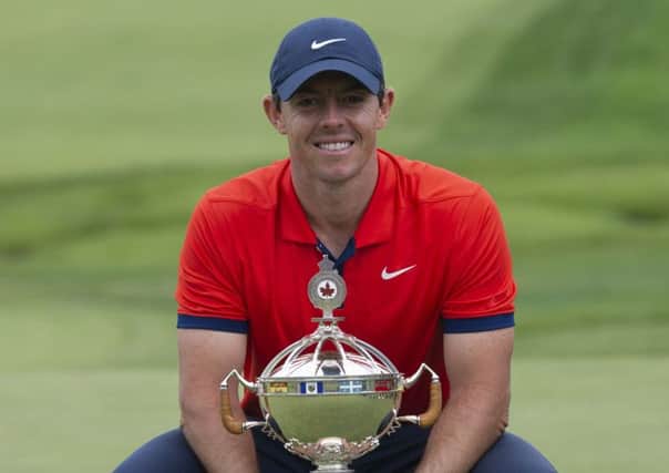 Rory McIlroy poses with the trophy after winning the Canadian Open