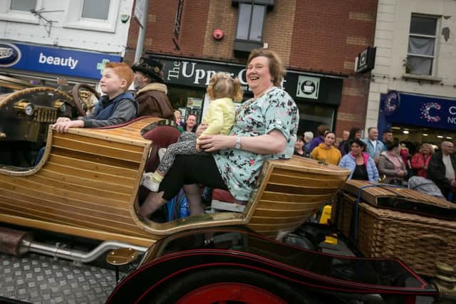 The Mayor, Cllr Maureen Morrow, and young festivalgoers enjoy the Chitty Chitty Bang Bang experience in the parade.