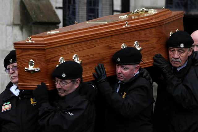 The coffin of former Provisional IRA leader Billy McKee is carried from St. Peter's Cathedral, Belfast, by members of 'D Company'.