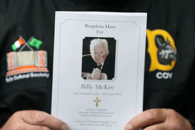 A member of 'D Company' holds a mass card at the funeral of former Provisional IRA leader Billy McKee at St. Peter's Cathedral, Belfast.