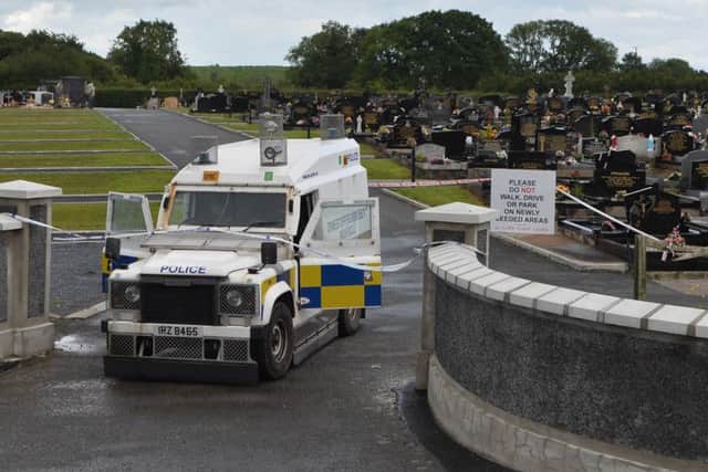 Police at the scene of a security alert at a  Lurgan cemetery on Monday. I
t is understood the Army bomb disposal team has been called to St Coleman's graveyard in Lurgan, Co Armagh.
Photo: Colm Lenaghan/Pacemaker