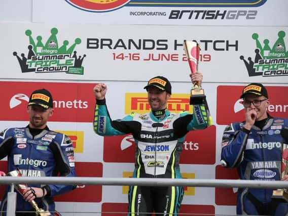 Alastair Seeley celebrates his victory in the British Supersport Sprint race with runner-up Jack Kennedy (left) and Brad Jones.