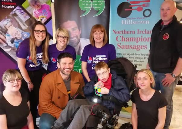 Singer George Hutton with representatives from the NI Children's Hospice and Sam McBride from Ballymena who has received care there