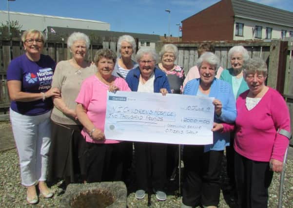 Roma Brown from the Larne Support Group receiving a cheque for £2000 for the Children's Hospice from the ladies of the Greenland Senior Citizens' Club.