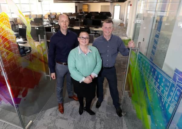 Novosco's John Lennon, Director, Ellen Dickson, Client Director, and David Neeson, Programme Manager, officially open the company's expanded office at Catalyst Inc in Titanic Quarter, Belfast.