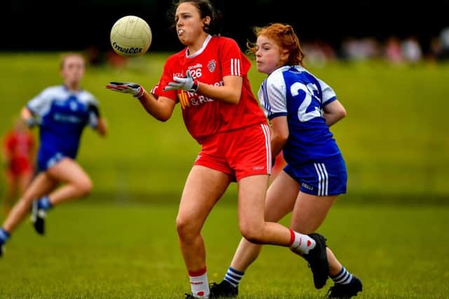 ;Olivia McGuiness of Tyrone in action against Dervla Cawley of Monaghan