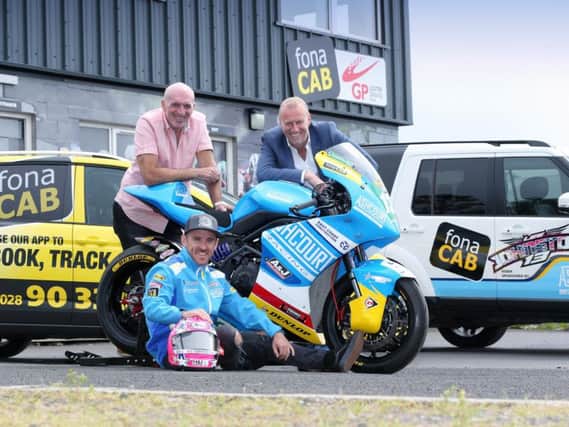 Top road racer Lee Johnston with Ulster Grand Prix Clerk of the Course, Noel Johnston, and William McCausland, Managing Director, fonaCAB.