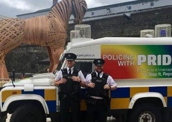 PSNI officers with a Land Rover in Pride colours