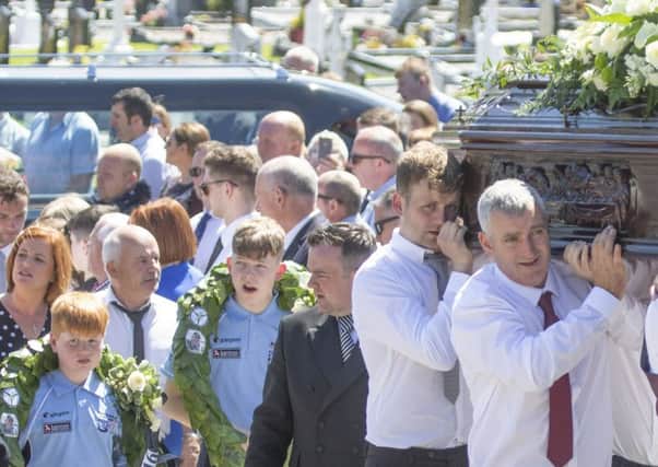 The remains of the late rally driver Manus "Mandy" Kelly are carried his resting place in Conwal graveyard in Donegal as his sons wear garlands from his wins in the Donegal International Rally. Press Association picture