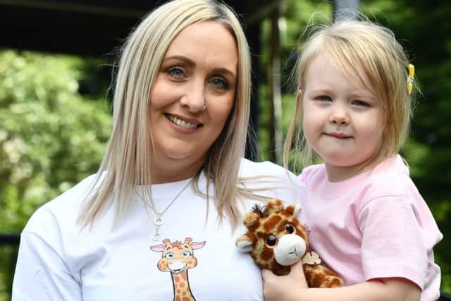 PACEMAKER BELFAST  28/06/2019 George's Mum Kirsty Doherty watches on with her daughter Grace and Family and Friends as George (the Giraffe) came outside for the first time for visitors.