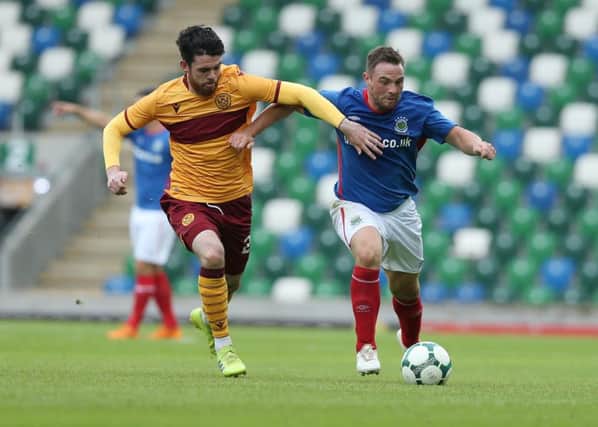 Linfield  Jamie Mulgrew  and Motherwell Liam Gallagher during Saturday's friendly match at Windsor Park.
 (Picture by Brian Little)