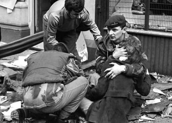 The soldier cradling Ms Suehiro in the aftermath of the explosion. Associated Press photograph.