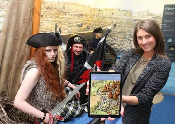 Sarah Travers launches the Portrush Heritage App with Portrush pirate Tavish Dhu and Chairman John McNally .
