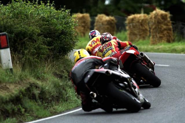 Joey Dunlop (Honda RC45) chases after V&M Yamaha riders Iain Duffus and David Jefferies at the 1999 Ulster Grand Prix.