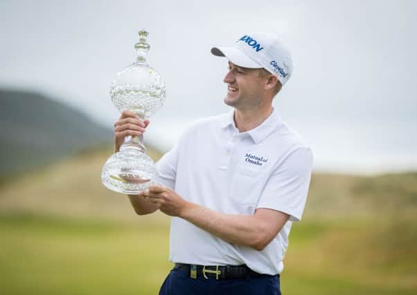 Russell Knox with the 2018 Dubai Duty Free Irish Open trophy. Pic by INPHO.