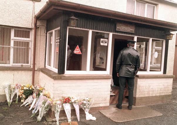 A policeman stands at the scene of the Loughinisland massacre