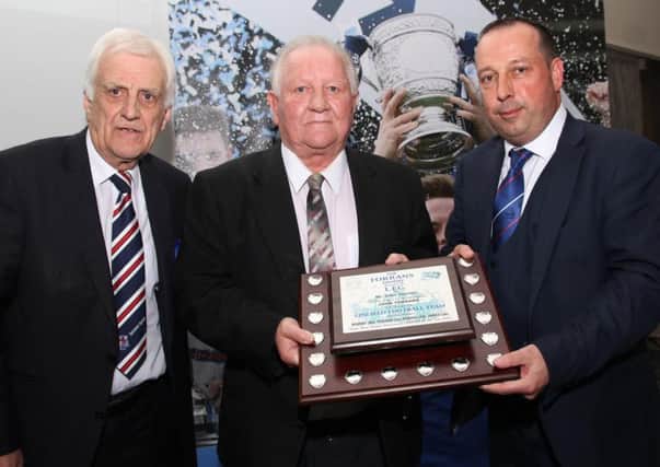Sammy Pavis pictured receiving the Torrans Trophy from Billy Kennedy and Roy McGivern in 2018