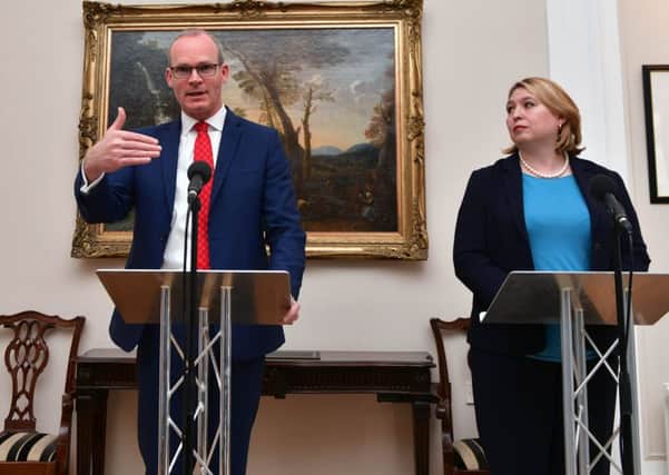 Simon Coveney and Karen Bradley at Stormont in April. "The two governments have strived to avoid dealing with crimes, as in their view that is necessary for the political process. Essentially to ignore murder! They failed to resource our criminal justice system to enable it to bring to justice those responsible for those crimes." 
Photo Colm Lenaghan/Pacemaker Press