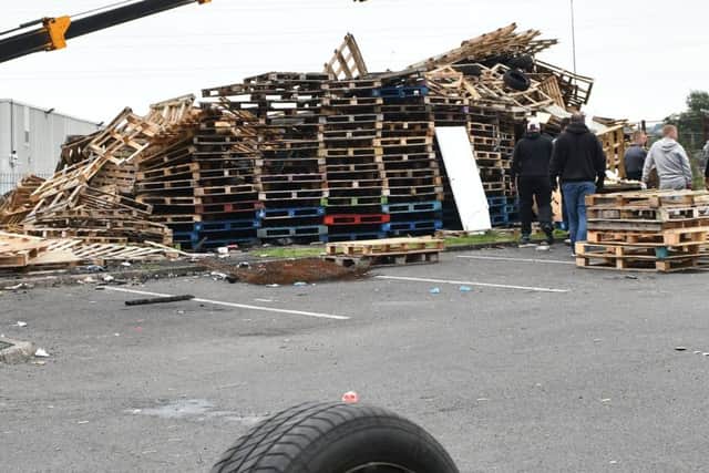 PACEMAKER BELFAST  08/07/2019
Bonfire builders at the Avoniel Leisure Centre site voluntarily remove tyres from their bonfire this afternoon after a ruling from the City Council.
A council committee has decided to "act in the public interest" and remove materials from two bonfires in east Belfast.The Strategic Policy and Resources Committee met on Monday afternoon to discuss up to eight sites where bonfires have been erected.
Photo Pacemaker Press